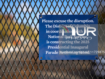 A sign hanging on a fence informs people of construction for the 2025 Presidential Inaugural Parade Reviewing Stand on Pennsylvania Avenue o...