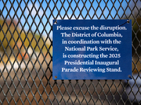 A sign hanging on a fence informs people of construction for the 2025 Presidential Inaugural Parade Reviewing Stand on Pennsylvania Avenue o...