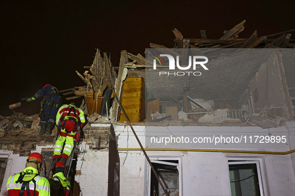 Rescuers work at a house destroyed by a Russian missile strike in Kharkiv, Ukraine, on November 1, 2024. NO USE RUSSIA. NO USE BELARUS. 