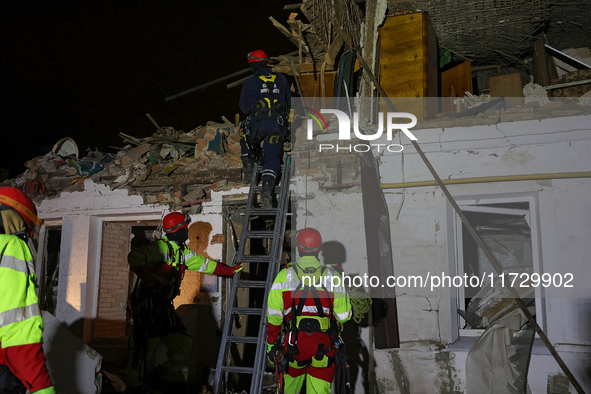 Rescuers work at a house destroyed by a Russian missile strike in Kharkiv, Ukraine, on November 1, 2024. NO USE RUSSIA. NO USE BELARUS. 