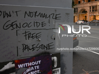 Seen beyond graffiti on a utility box near the White House, storefronts are covered by plywood in Washington, D.C. on November 1, 2024 in pr...