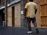 A person walks past boarded up storefronts near the White House in Washington, D.C. on November 1, 2024 as local busineses prepare for possi...