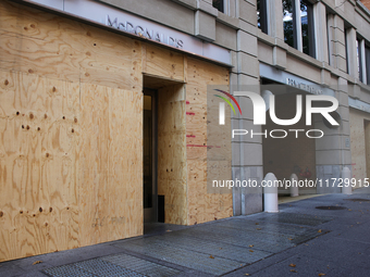 Storefronts are seen covered near the White House in Washington, D.C. on November 1, 2024 in preparation for possible civil unrest related t...