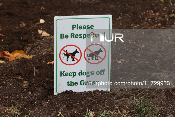 A sign asks dog owners to keep their dogs off the grass in front of a home in Vaughan, Ontario, Canada, on October 31, 2024. 