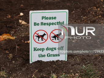 A sign asks dog owners to keep their dogs off the grass in front of a home in Vaughan, Ontario, Canada, on October 31, 2024. (