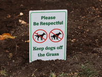 A sign asks dog owners to keep their dogs off the grass in front of a home in Vaughan, Ontario, Canada, on October 31, 2024. (