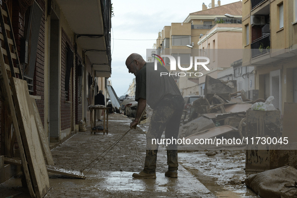 People clear mud and possessions from their homes after flash flooding in Paiporta, Spain, on November 1, 2024. 