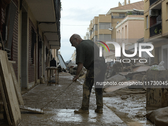 People clear mud and possessions from their homes after flash flooding in Paiporta, Spain, on November 1, 2024. (