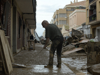 People clear mud and possessions from their homes after flash flooding in Paiporta, Spain, on November 1, 2024. (