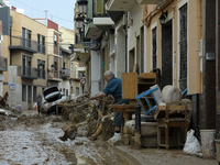 People clear mud and possessions from their homes after flash flooding in Paiporta, Spain, on November 1, 2024. (