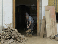 People clear mud and possessions from their homes after flash flooding in Paiporta, Spain, on November 1, 2024. (