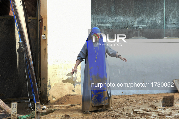 People clear mud and possessions from their homes after flash flooding in Paiporta, Spain, on November 1, 2024. 