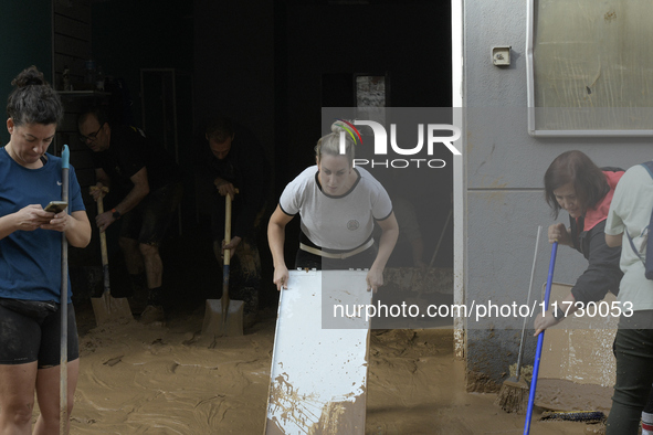 People clear mud and possessions from their homes after flash flooding in Paiporta, Spain, on November 1, 2024. 