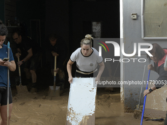 People clear mud and possessions from their homes after flash flooding in Paiporta, Spain, on November 1, 2024. (