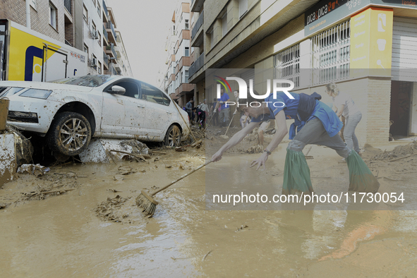 People clear mud and possessions from their homes after flash flooding in Paiporta, Spain, on November 1, 2024. 