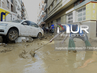 People clear mud and possessions from their homes after flash flooding in Paiporta, Spain, on November 1, 2024. (