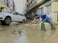 People clear mud and possessions from their homes after flash flooding in Paiporta, Spain, on November 1, 2024. (