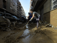 People clear mud and possessions from their homes after flash flooding in Paiporta, Spain, on November 1, 2024. (