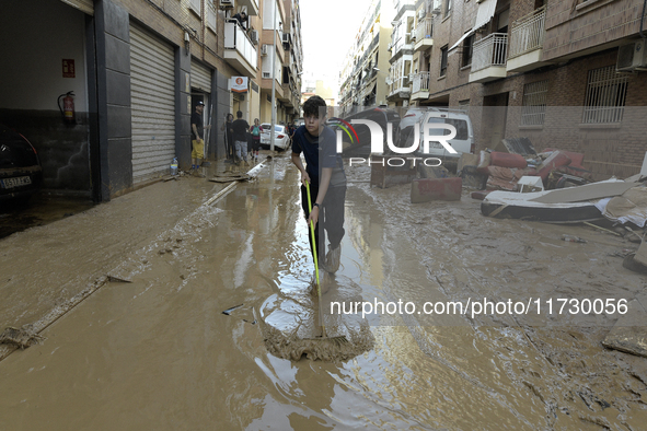 People clear mud and possessions from their homes after flash flooding in Paiporta, Spain, on November 1, 2024. 