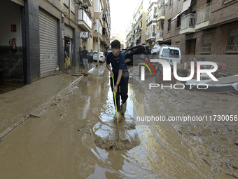 People clear mud and possessions from their homes after flash flooding in Paiporta, Spain, on November 1, 2024. (