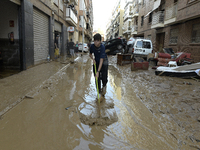 People clear mud and possessions from their homes after flash flooding in Paiporta, Spain, on November 1, 2024. (