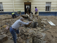 People clear mud and possessions from their homes after flash flooding in Paiporta, Spain, on November 1, 2024. (