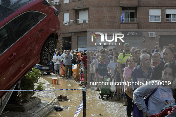 Water and other supplies are shared in the street of Paiporta in Valencia, Spain, on November 1, 2024. 