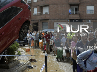 Water and other supplies are shared in the street of Paiporta in Valencia, Spain, on November 1, 2024. (