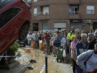 Water and other supplies are shared in the street of Paiporta in Valencia, Spain, on November 1, 2024. (