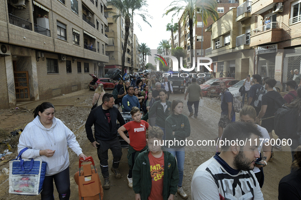 Water and other supplies are shared in the street of Paiporta in Valencia, Spain, on November 1, 2024. 