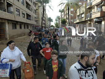 Water and other supplies are shared in the street of Paiporta in Valencia, Spain, on November 1, 2024. (