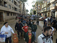 Water and other supplies are shared in the street of Paiporta in Valencia, Spain, on November 1, 2024. (