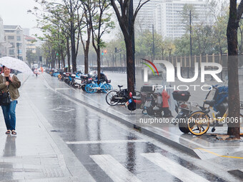 A pedestrian walks with an umbrella as Typhoon Kong-Rey brings strong winds and heavy rain in Shanghai, China, on November 1, 2024. (