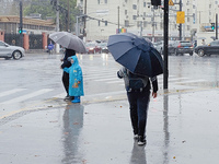 A pedestrian walks with an umbrella as Typhoon Kong-Rey brings strong winds and heavy rain in Shanghai, China, on November 1, 2024. (