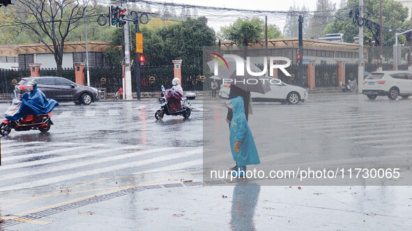 A pedestrian walks with an umbrella as Typhoon Kong-Rey brings strong winds and heavy rain in Shanghai, China, on November 1, 2024. 