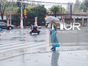 A pedestrian walks with an umbrella as Typhoon Kong-Rey brings strong winds and heavy rain in Shanghai, China, on November 1, 2024. (