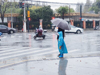 A pedestrian walks with an umbrella as Typhoon Kong-Rey brings strong winds and heavy rain in Shanghai, China, on November 1, 2024. (