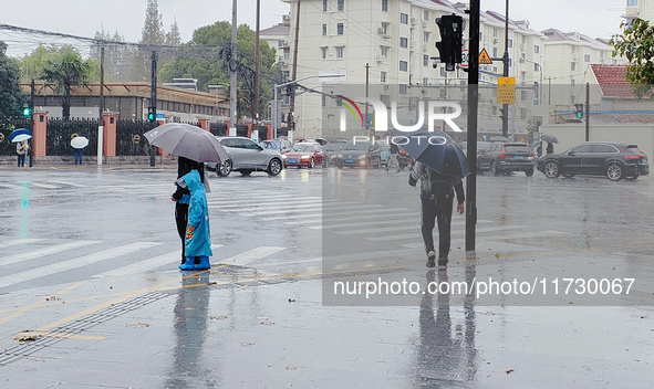 A pedestrian walks with an umbrella as Typhoon Kong-Rey brings strong winds and heavy rain in Shanghai, China, on November 1, 2024. 