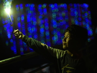 A boy smiles while holding sparklers during Laxmi Puja as part of the Tihar or Deepawali and Diwali celebrations in Kathmandu, Nepal, on Nov...