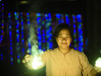 A woman holds sparklers during Laxmi Puja as part of the Tihar or Deepawali and Diwali celebrations in Kathmandu, Nepal, on November 1, 2024...