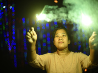 A woman holds sparklers during Laxmi Puja as part of the Tihar or Deepawali and Diwali celebrations in Kathmandu, Nepal, on November 1, 2024...