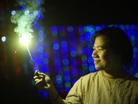 A woman holds sparklers during Laxmi Puja as part of the Tihar or Deepawali and Diwali celebrations in Kathmandu, Nepal, on November 1, 2024...