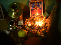 A Nepalese devotee offers a ritual prayer towards a poster of Laxmi Puja during the procession of Tihar or Deepawali and Diwali celebrations...