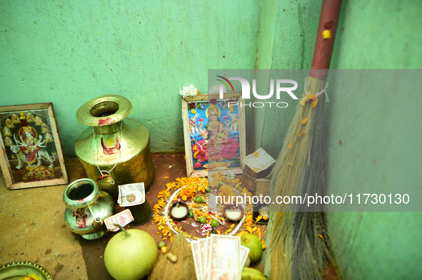 A Nepalese devotee offers a ritual prayer towards a poster of Laxmi Puja during the procession of Tihar or Deepawali and Diwali celebrations...