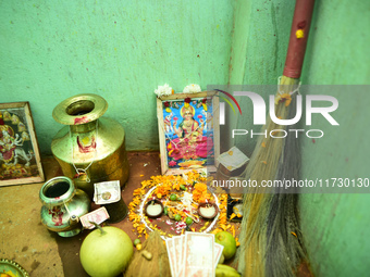 A Nepalese devotee offers a ritual prayer towards a poster of Laxmi Puja during the procession of Tihar or Deepawali and Diwali celebrations...