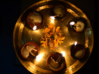 A devotee offers clay pot lamps during Laxmi Puja as part of the Tihar or Deepawali and Diwali celebrations in Kathmandu, Nepal, on November...