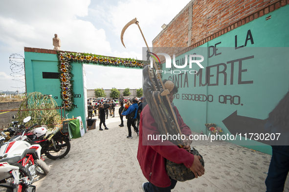 A faithful carries a Santa Muerte image to bless it at the temple of Santa Muerte in the municipality of Pedro Escobedo, Mexico, on November...