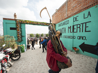 A faithful carries a Santa Muerte image to bless it at the temple of Santa Muerte in the municipality of Pedro Escobedo, Mexico, on November...