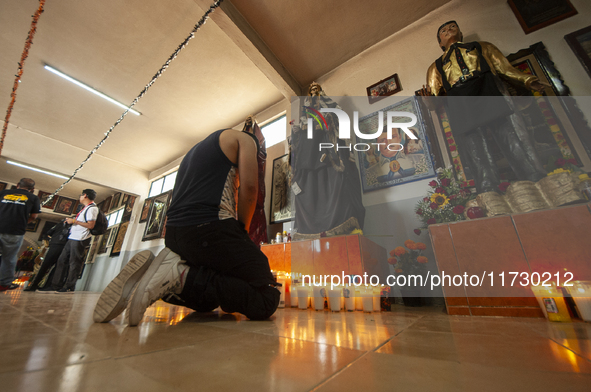 A faithful attends the temple of Santa Muerte in the municipality of Pedro Escobedo, Mexico, on November 1, 2024, to worship her and give th...