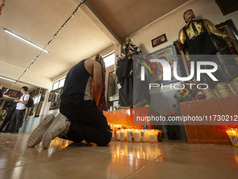 A faithful attends the temple of Santa Muerte in the municipality of Pedro Escobedo, Mexico, on November 1, 2024, to worship her and give th...